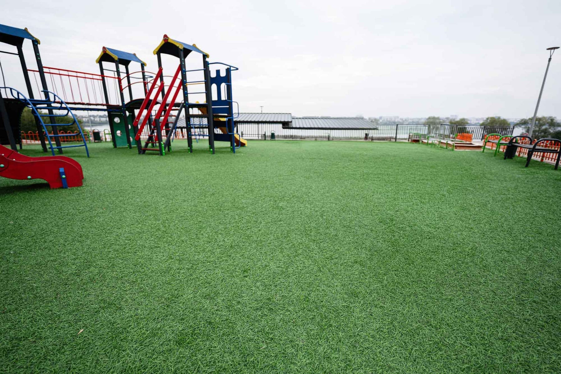 Artificial turf playground surfacing under commercial play equipment - Rymar manufacturer photo