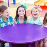 Children at a Grounds For Play Fun Table on a playground