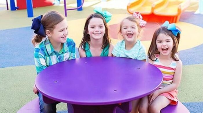 Children at a Grounds For Play Fun Table on a playground