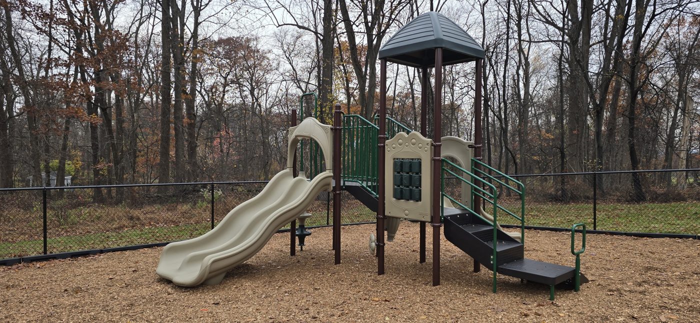 Little Brook Montessori playground in West Caldwell, NJ, preschool play structure with slide and roofed tower
