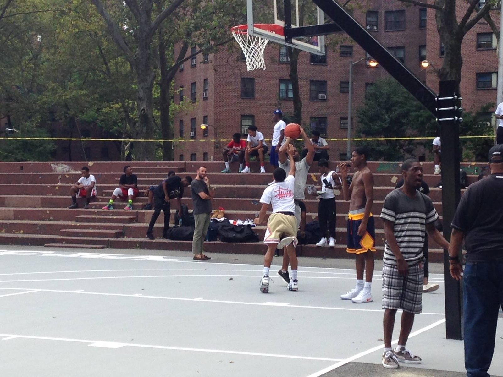 Pickup basketball game at an in-ground goal on a city park court