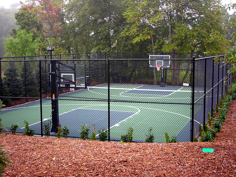 Fenced multi-sport court with basketball hoops