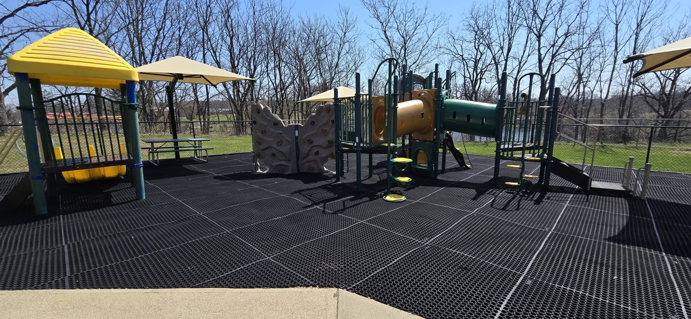 Second Home Childcare Center playground in Wantage, NJ, play structure with climbing wall and shade umbrellas over the play area