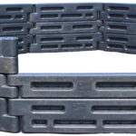 2by2 Industries in-ground high-wall gaga ball pit, three rows of black plastic border timbers with an entry cutout