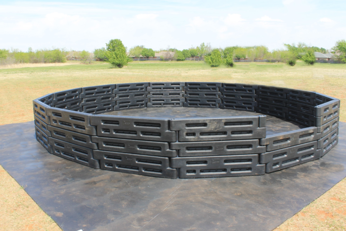 20 foot high-wall gaga ball pit set up on a field, three rows of plastic border timbers