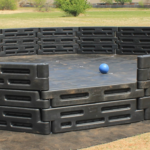 26 foot high-wall gaga ball pit, three rows of plastic border timbers around a wide playing area