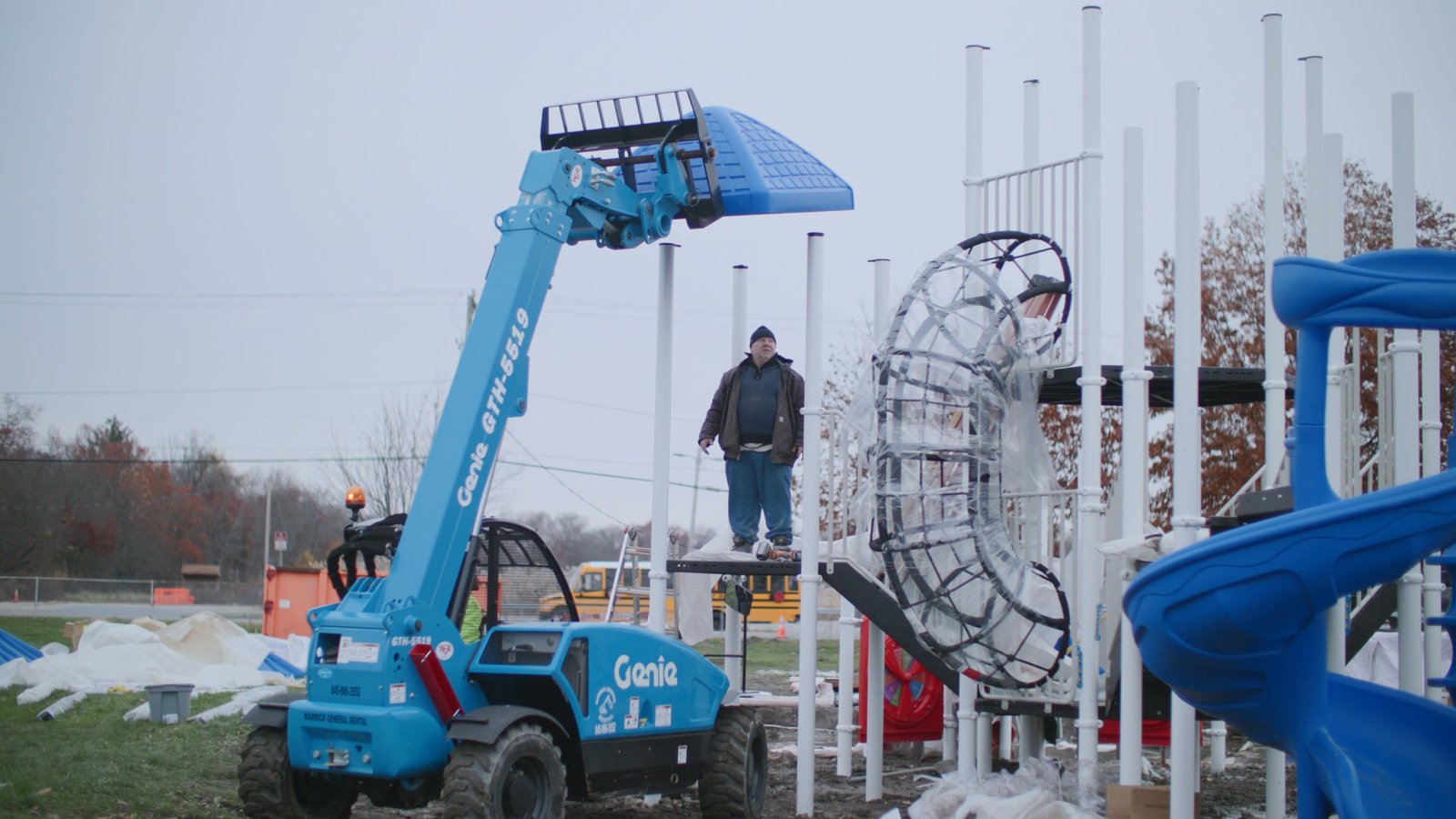 Crew installing a playground structure with a telehandler at Erie Street Park, Village of Goshen